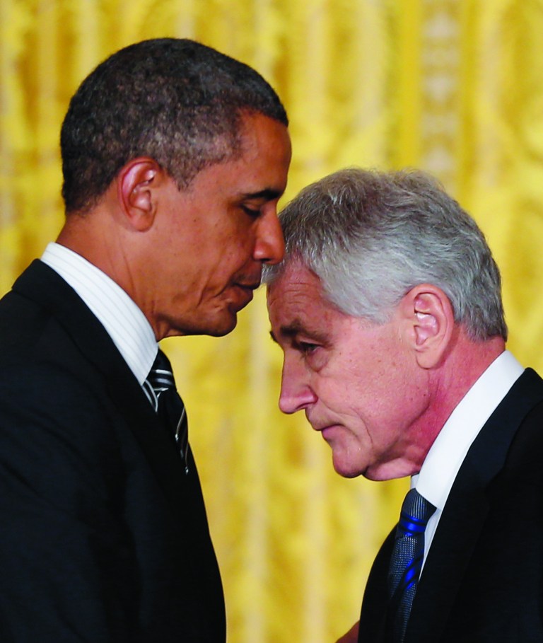 FILE - In this Jan. 7, 2013 file photo, President Barack Obama, left, and former U.S. Sen. Chuck Hagel, R-Neb., walk past each other during a new conference in the East Room of the White House in Washington, to announce that he is nominating Hagel, as the new Defense Secretary. Senate Republicans' reservations about Hagel heading the Pentagon is caught up in potent politics, from a proxy fight over President Barack Obama to more parochial concerns about nuclear weapons works. (AP Photo/Carolyn Kaster, File)
