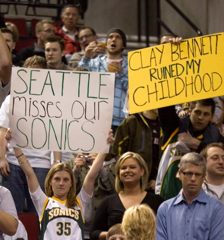   FILE - In this Feb. 11, 2009, file photo, Seattle SuperSonics fans show their displeasure when the Oklahoma City Thunder, formerly the SuperSonics, were introduced during an NBA basketball game against the Portland Trail Blazers, in Portland, Ore. Before they became critically acclaimed documentary filmmakers, Adam Brown and Jason Reid, not shown, were simply basketball junkies. And being hoops aficionados, Brown and Reid can appreciate the way the Oklahoma City Thunder play on the court. But all it takes is one screen shot of owner Clay Bennett or one mention of the Thunder's past incarnation as the Seattle SuperSonics to help them recall why they can never cheer for that team.(AP Photo/Don Ryan, file)  