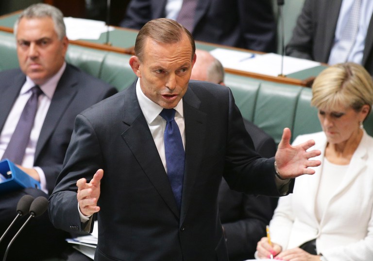Australia's Prime Minister Tony Abbott gestures as he speaks about the nation's new anti-extremism strategy during a question time at Parliament House in Canberra, Australia, Monday, Feb. 23, 2015. (AP Photo/Rob Griffith)