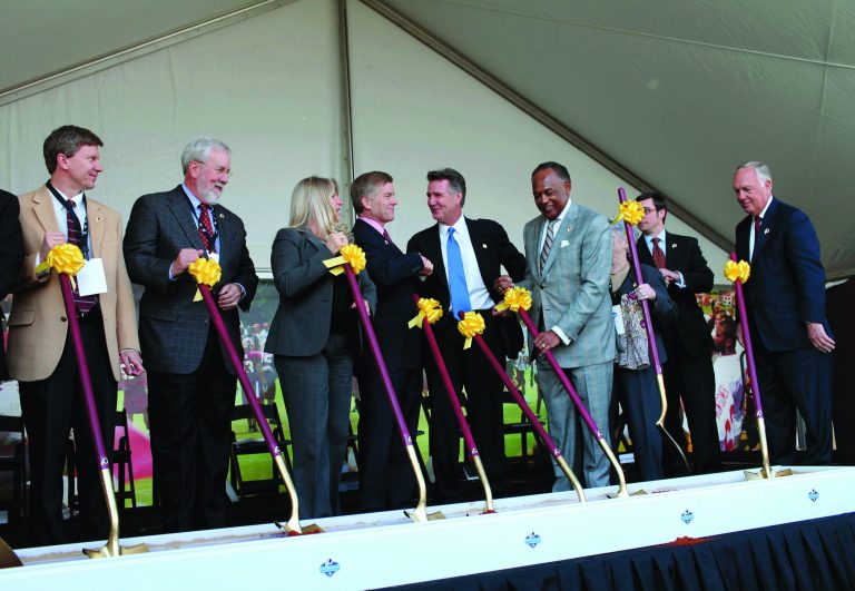 Daniel Sangjib Min/Richmond Times-Dispatch via AP
Bruce Allen, center right shaking hands with Virginia Gov. Bob McDonnell, said the Redskins don't consider their name offensive and won't change it.