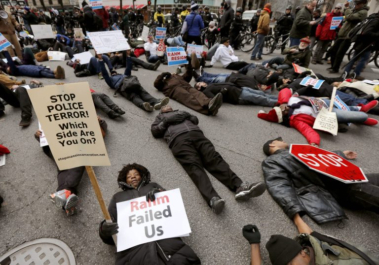 The Christmas Eve protest is the latest in a series of demonstrations in the city since the release last month of police video showing a white officer shooting a black teenager 16 times. (AP Photo/Charles Rex Arbogast)