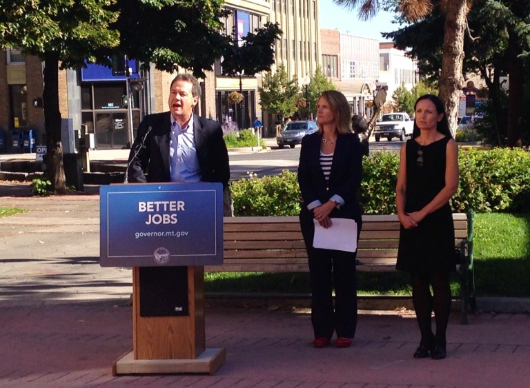 Montana Gov. Steve Bullock presents the Montana Department of Labor and Industry's Labor Day report released Friday, Aug. 29, 2014, in Helena, Mont., while Montana Labor and Industry Commissioner Pam Bucy, center, and Lt. Gov. Angela McLean listen. State officials say Montana ranks in the top five states for employment growth, but it faces slower growth in the future as an aging workforce retires.  (AP Photo/Lisa Baumann)