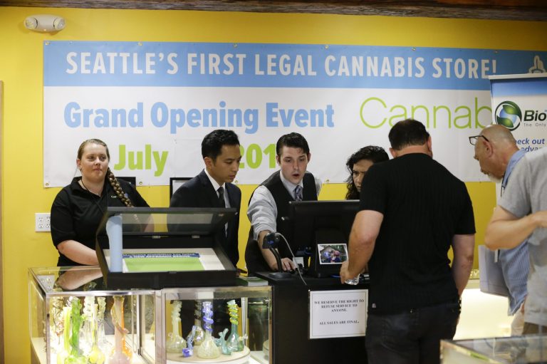 Employees prepare for opening day at the Cannabis City retail marijuana store on July 8, 2014 in Seattle, Washington. (Pool photo by Elaine Thompson/AP)