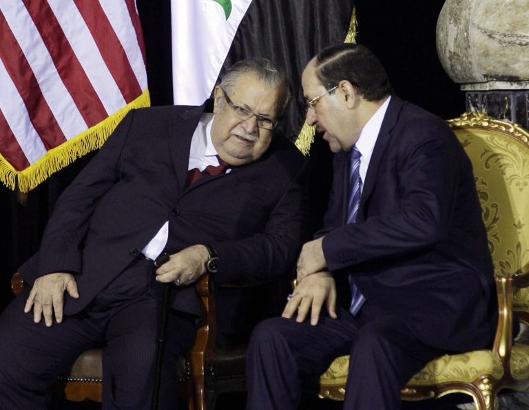   FILE - In this Dec. 1, 2011 file photo, Iraqi President Jalal Talabani, left, and Iraqi Prime Minister Nouri al-Maliki, chat during a special ceremony at Camp Victory in Baghdad. Opponents of Al-Maliki have failed to muster enough support to bring him down in a vote of no confidence, Talabani said in a statement posted on his website Sunday, June 10, 2012. (AP Photo/Khalid Mohammed, Pool, File)  
