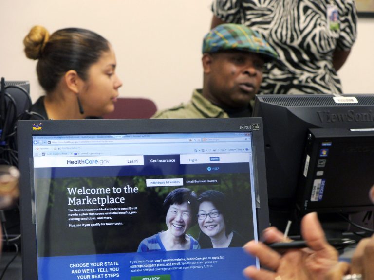 Parkland Memorial Hospital financial counselor Tiffany Ruiz, left, helps Vyncent Bosh sign up for insurance under the Affordable Care Act on Friday in Dallas. (AP Photo/The Dallas Morning News, Ron Baselice)