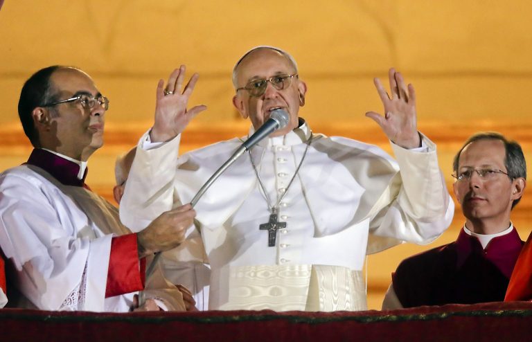 FILE -- In this file photo taken on March 13, 2013, Pope Francis waves to the crowd from the central balcony of St. Peter's Basilica at the Vatican, the day of his election. From his gestures to his simple soundbites to his emphasis that priests are called to serve, Pope Francis has endeared himself to the public, radically shifted the paradigm of the papacy and reminded the world that the church's mission is one of mercy. (AP Photo/Gregorio Borgia)