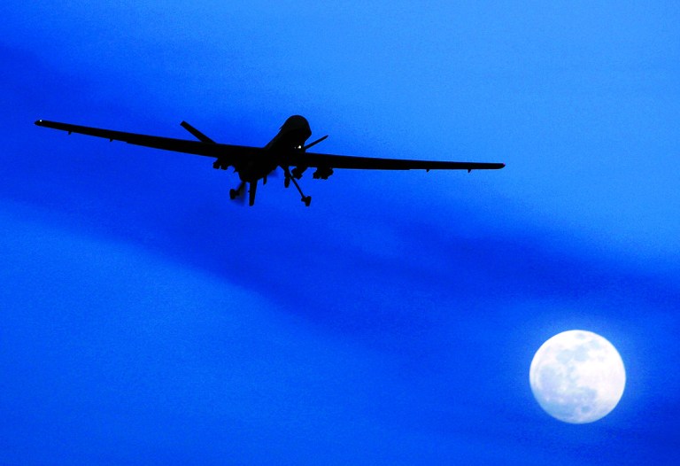 FILE - In this Jan. 31, 2010 file photo an unmanned U.S. Predator drone flies over Kandahar Air Field, southern Afghanistan, on a moon-lit night. Drones are often called the weapon of choice of the Obama administration, which quadrupled drone strikes against al-Qaida targets in Pakistan's lawless tribal areas, up from less than 50 under the Bush administration to more than 220 in the past three years.  (AP Photo/Kirsty Wigglesworth, File)