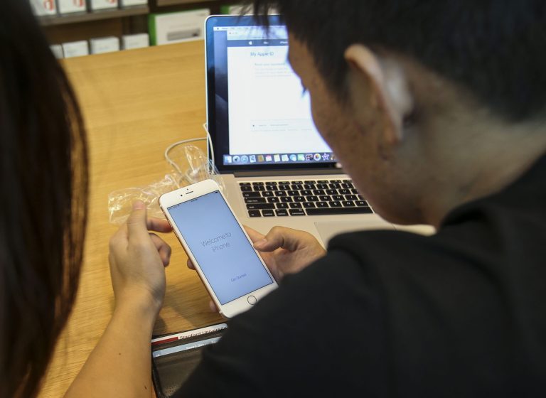 A customer tries out his new Apple iPhone 6s Plus smartphone Friday, Sept. 25, 2015 at the Apple store at The Grove in Los Angeles. (AP Photo/Ringo H.W. Chiu)