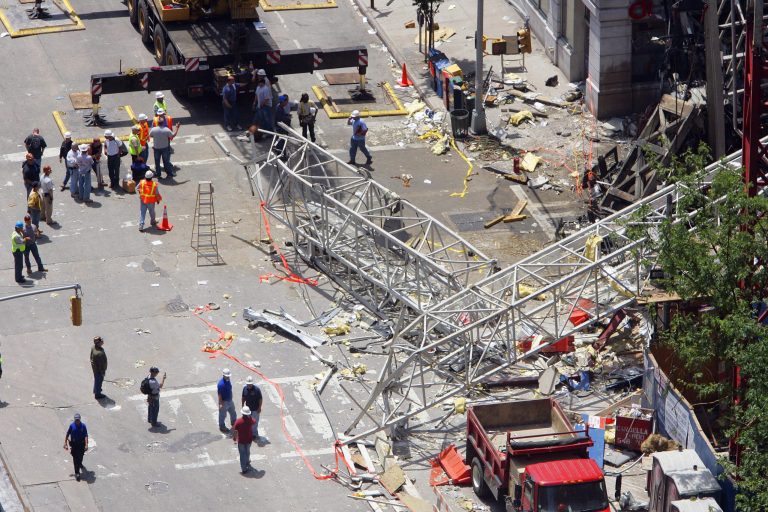 FILE - In this May 30, 2008 file photo, crews work at the scene of a crane collapse on the Upper East Side of New York. The New York City construction crane owner who was acquitted of manslaughter in a collapse that killed two workers has gone on trial again in a civil wrongful death case. Lawyers for the slain workers' families gave opening statements on Friday, May 23, 2014 in the trial of James Lomma, his company and others involved in the accident. (AP Photo/Stephen Chernin, File)
