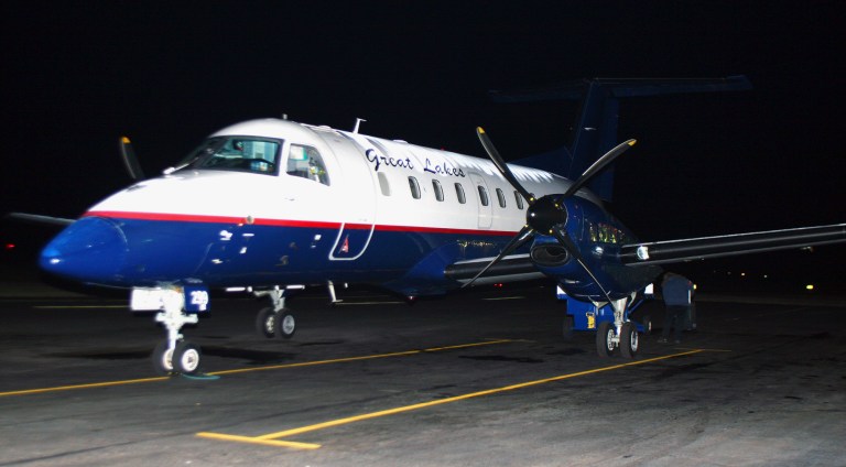 FILE - In this Nov. 1, 2010 file photo, a Great Lakes Airlines passenger plane is seen at the Havre City-County Airport in Havre, Mont. In North Dakota, Great Lakes will suspend service to the Dickinson and Williston airports by the end of the March 2014, after having pulled out of Devils Lake and Jamestown the month before. The Wyoming-based company has said it is pulling out of several regional airports because of problems retaining pilots, citing new federal rules that require co-pilots to log 1,500 flight hours before they can work for commercial airlines. (AP Photo/Havre Daily News, Nikki Carlson, File)