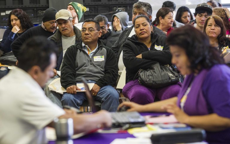 Applicants wait during a health care enrollment event at SEIU-UHW office, Monday, March 31, 2014, in Commerce, Calif.  Monday marks this year's open enrollment deadline, but consumers will get extra time to finish their applications.  (AP Photo/Ringo H.W. Chiu)