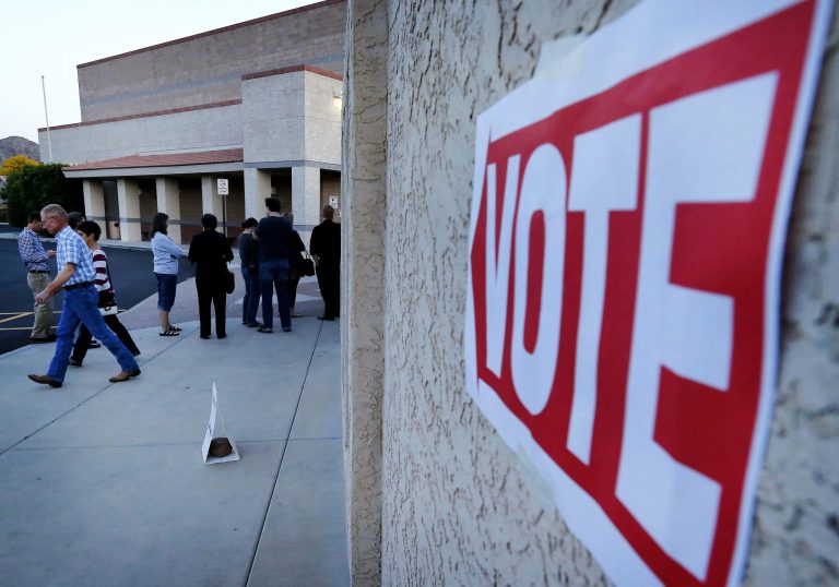 Some Arizona voters waited in line for hours after polls officially closed on Tuesday. (AP Photo/Matt York)