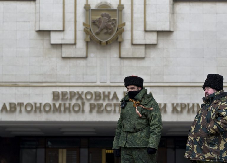 Cossack guards stand in front of Crimea's regional parliament building in Simferopol, Ukraine, on March 11. Crimea's regional legislature on Tuesday adopted a 