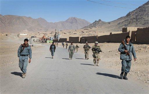 Afghan policemen walk ahead of the U.S. soldiers with the NATO- led International Security Assistance Force (ISAF) during a foot patrol in Kandahar, south of Kabul, Afghanistan, in this Jan. 7, 2012 file photo.