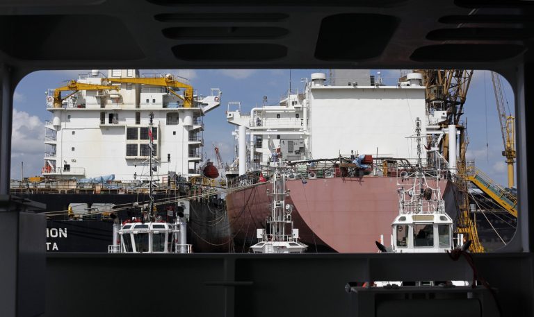   FILE - In this Jan. 24, 2011 file photo, cargo ships are framed through the deck of a heavy lift vessel in Singapore. Asia is girding for a worsening Europe crisis that has already stifled demand for exports that have powered growth and given hundreds of millions a higher standard of living. (AP Photo/Wong Maye-E, File)  