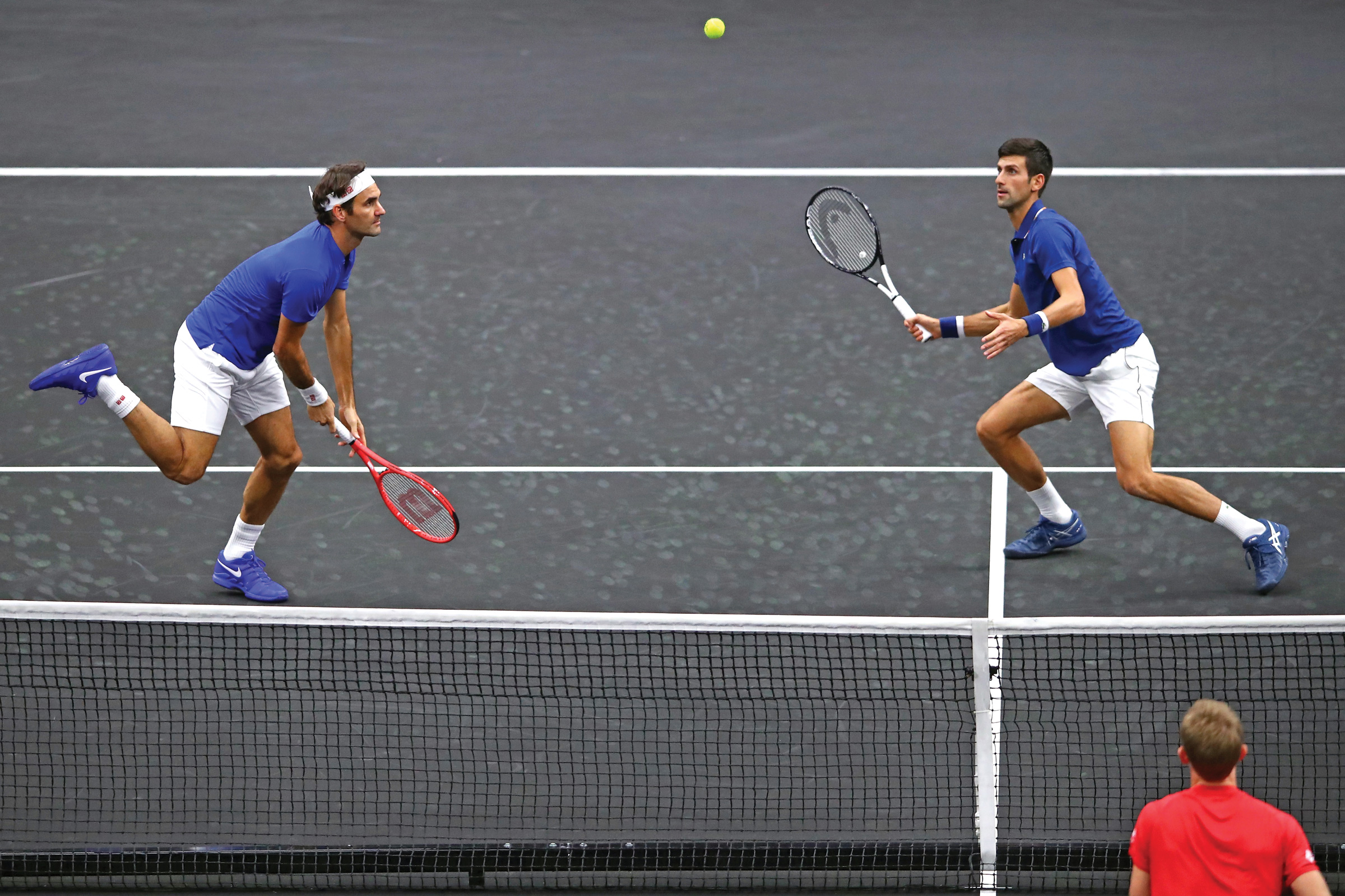 Roger Federer and Novak Djokovic playing doubles.