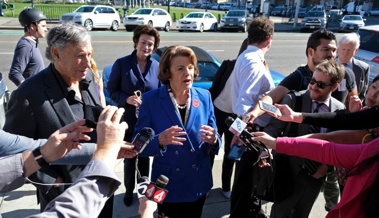 Sen. Dianne Feinstein talks with reporters after dropping off her vote-by-mail ballot outside City Hall Monday, Nov. 5, 2018, in San Francisco.