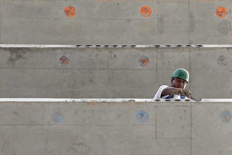 In this photo taken July 22, 2014, a construction worker is seen on a 36 floor high rise condominium in Miami. The Commerce Department reports on U.S. construction spending in July on Tuesday, Sept. 2, 2014. (AP Photo/Alan Diaz)