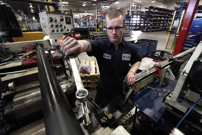 In this May 22, 2013 photo, Kenneth Paull works on a machine at Dokka Fasteners in Auburn Hills, Mich. The Commerce Department will report on business stockpiles for February 2014 on Monday, April 14, 2014. (AP Photo/Paul Sancya)