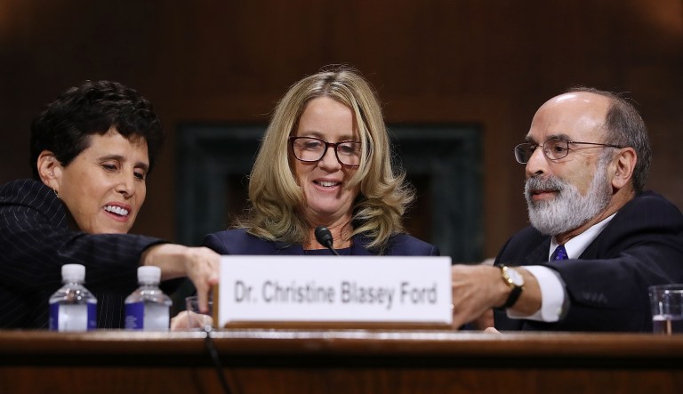 Christine Blasey Ford, center, is assisted by her attorneys Debra Katz, left, and Michael Bromwich before testifying during a Senate Judiciary Committee hearing in Washington, D.C., U.S., on Thursday, Sept. 27, 2018. ChairmanÂ Chuck GrassleyÂ called for a "safe, comfortable and dignified" hearing Thursday on a sexual assault allegation againstÂ BrettÂ KavanaughÂ as the panel opened a historic hearing that promises to shape the Supreme Court's future and redefine the "Me Too" era.