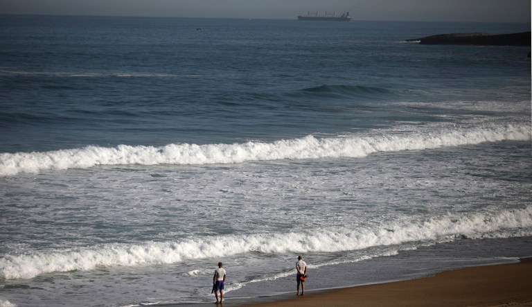 Police officers looks out to sea from a deserted beach on the first day of the G-7 summit in Biarritz, France Saturday, Aug. 24, 2019. 