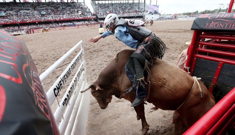 FILE - In this July 22, 2019, file photo, J.T. Moore, of Alvin, Texas, competes in bull riding at Frontier Park Arena in Cheyenne, Wyo., during the Cheyenne Frontier Days event. Cheyenne Frontier Days has been canceled for the first time in its 124-year history due to the coronavirus. Cheyenne Mayor Marian Orr said Wednesday, May 27, 2020 that organizers decided the risk of spreading the coronavirus was too great for the more than 140,000 people who visit Cheyenne for Frontier Days in late July.