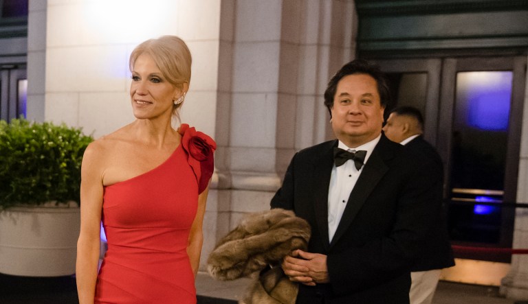 In this Thursday, Jan. 19, 2017 photo, President-elect Donald Trump adviser Kellyanne Conway, center, accompanied by her husband, George, speaks with members of the media as they arrive for a dinner at Union Station in Washington, the day before Trump's inauguration.