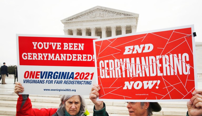 Sara Fitzgerald, left, and Michael Martin, both with the group One Virginia, protest gerrymandering in front of the Supreme Court, Wednesday, March 28, 2018, in Washington where the court will hear arguments on a gerrymandering case. The Supreme Court is taking up its second big partisan redistricting case of the term amid signs the justices could place limits on drawing maps for political gain.