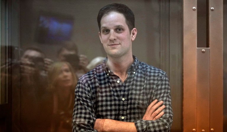 Wall Street Journal reporter Evan Gershkovich stands in a glass cage in a courtroom at the Moscow City Court, in Moscow, Russia, Tuesday, April 18, 2023.