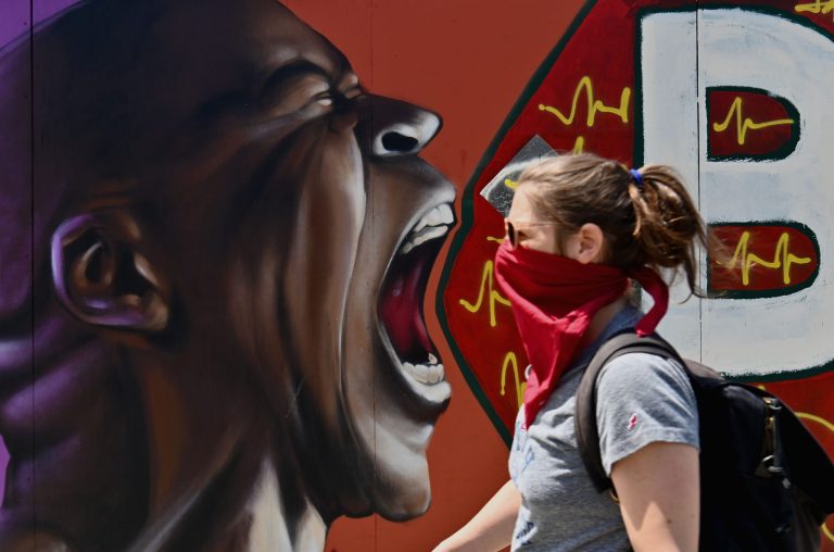 A person walks past a street mural by artist Vincent Ballentine on June 16, 2020, in the Brooklyn Borough of New York City. 