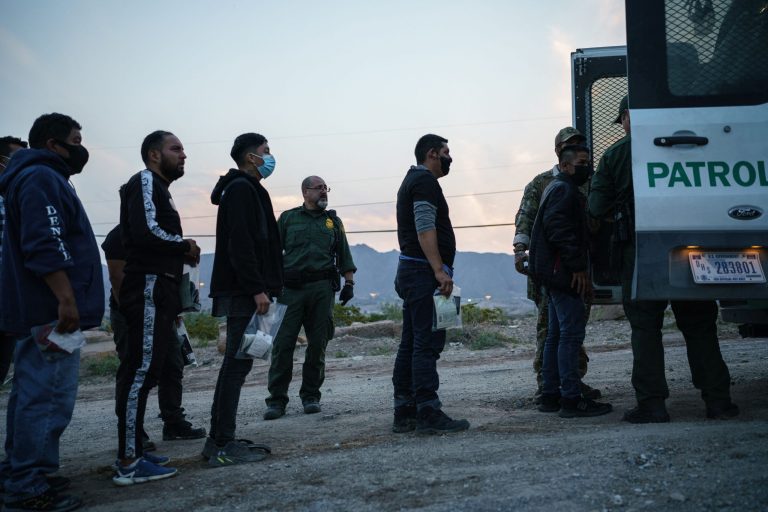 Migrants caught crossing the US-Mexico border are loaded into a transport van by US Border Patrol agents in Sunland Park, New Mexico on July 22, 2021. (Photo by PAUL RATJE / AFP) (Photo by PAUL RATJE/AFP via Getty Images)