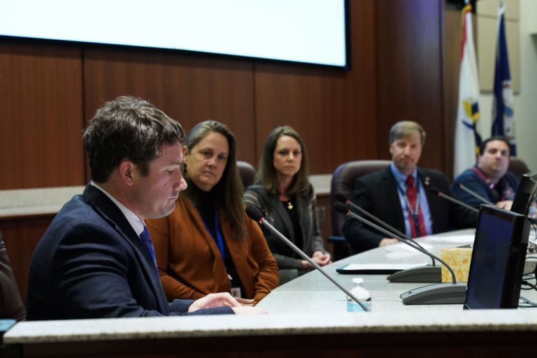 Dr. Daniel Smith (left) takes his place on the board after being appointed interim superintendent of Loudoun County Public Schools at an emergency board meeting at LCPS Administrative Offices.