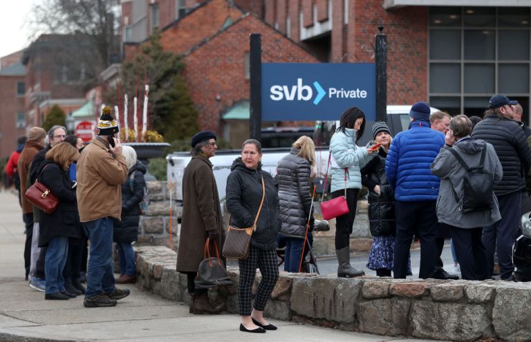 On March 13, 2023, bank customers in Wellesley, Massachusetts, line up outside Silicon Valley Bank following its collapse.