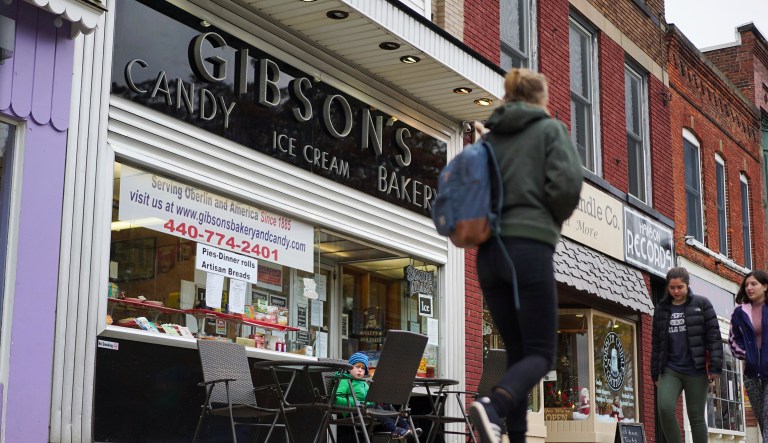 In this Nov. 22, 2017 file photo, pedestrians pass the storefront of Gibson's Food Mart & Bakery in Oberlin, Ohio.