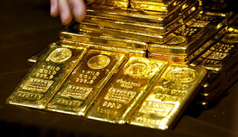 A staff member displays the gold bullion bars during a news conference at the Chinese Gold and Silver Exchange Society in Hong Kong Monday, Oct. 17, 2011. The Chinese Gold and Silver Exchange Society starts the first day gold trading in yuan on Monday in Hong Kong where becomes the first offshore market from China.