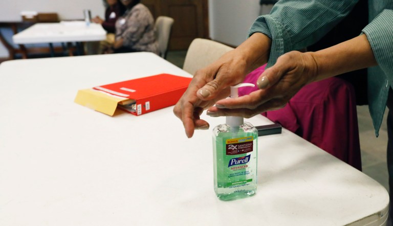 A voter takes advantage of the hand sanitizer to "clean up" after voting in the presidential party primary in Ridgeland, Miss., Tuesday, March 10, 2020. Polling locations are providing hand sanitizers for voters to use as a cautionary measure in light of the coronavirus health concern nationwide.