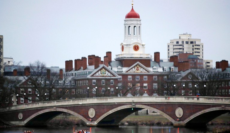 In this March 7, 2017 file photo, rowers paddle along the Charles River past the Harvard College campus in Cambridge, Massachusetts.