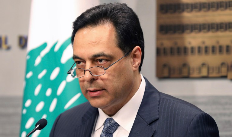 In this photo released by the Lebanese Government, Lebanese Prime Minister Hassan Diab, gives a speech at the Government House in Beirut, Lebanon, Saturday, March. 7, 2020. Lebanon's prime minister said Saturday the government will suspend payment of $1.2 billion in loans, marking the crisis-hit country's first-ever default on its sovereign debt. 