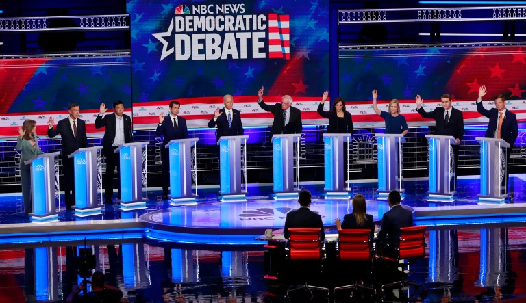 Democratic presidential candidates, author Marianne Williamson, former Colorado Gov. John Hickenlooper, entrepreneur Andrew Yang, South Bend Mayor Pete Buttigieg, former Vice President Joe Biden, Sen. Bernie Sanders, I-Vt., Sen. Kamala Harris, D-Calif., Sen. Kirsten Gillibrand, D-N.Y., former Colorado Sen. Michael Bennet, and Rep. Eric Swalwell, D-Calif., raise their hands when asked if they would provide healthcare for undocumented immigrants, during the Democratic primary debate hosted by NBC News at the Adrienne Arsht Center for the Performing Arts, Thursday, June 27, 2019, in Miami.