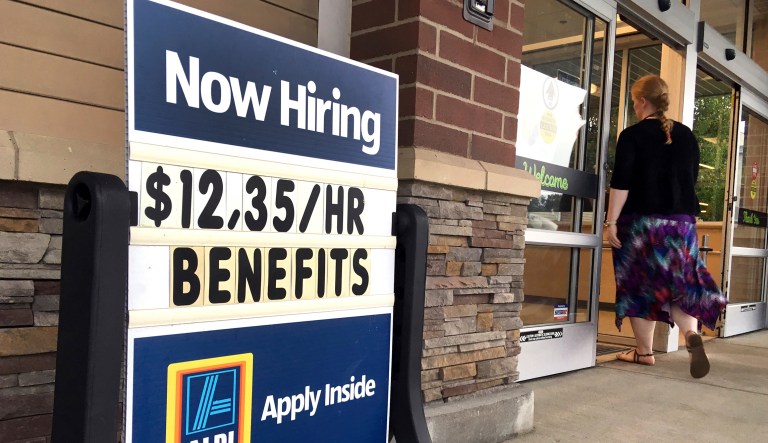 FILE- In this July 17, 2018, file photo, a sign outside a business in Salem, N.H. says "Now Hiring." On Tuesday, Oct. 16, the Labor Department reports on job openings and labor turnover for August.