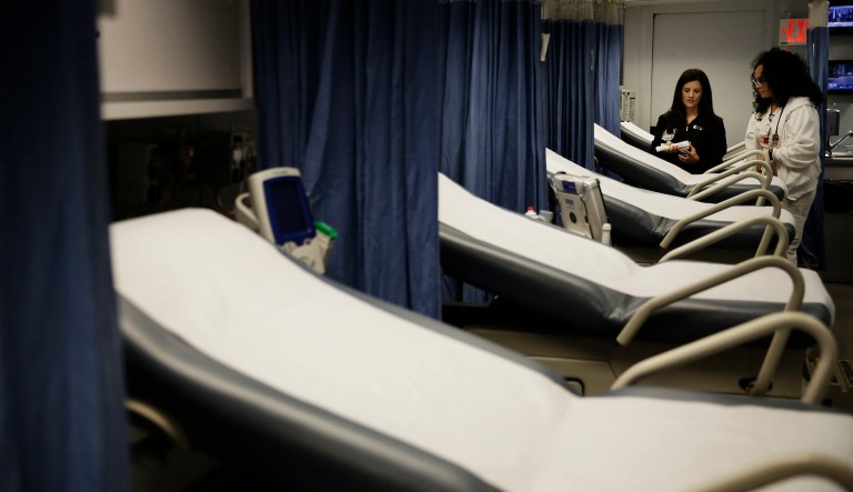 Nurses Kristy Haynes, left, and Crysta Swift look over supplies inside a mobile emergency room set up outside Grady Memorial Hospital to help handle the ever-growing number of flu cases in Atlanta, Monday, Jan. 29, 2018. The trailer, called Carolinas MED-1, has 14 beds and will sit outside the hospital's main emergency room for 30 days to alleviate wait times and bed shortages.