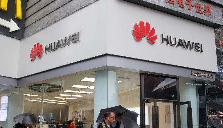 A man walks past a Huawei retail shop in Shenzhen, China's Guangdong province, Thursday, March 7, 2019. Chinese tech giant Huawei is challenging a U.S. law that labels the company a security risk and would limit its access to the American market for telecom equipment.
