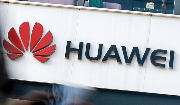 FILE - In this July 30, 2019, file photo a woman walks by a Huawei retail store in Beijing. The Trump administration has extended for 90 more days a limited reprieve on U.S. technology sales to the Chinese technology giant Huawei. The U.S. government blacklisted Huawei in May, deeming it a national security risk so U.S. firms aren't allow to sell the company technology without government approval. But numerous loopholes have been exploited, including by U.S. semiconductor suppliers. And the administration says itâs preparing to grand some exemptions.