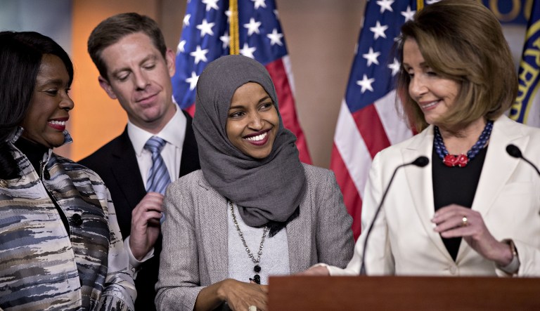Representative-elect Ilhan Omar, a Democrat from Minnesota, center, and Representative Terri Sewell, a Democrat from Alabama, left, smile during a news conference next to House Minority Leader Nancy Pelosi, a Democrat from California, right, on Capitol Hill in Washington, D.C., U.S., on Friday, Nov, 30, 2018. Pelosi this week cleared the first hurdle to serve as House speaker by winning Democrats nomination on Wednesday, leaving her detractors one last opportunity to attempt to block her when the entire chamber votes in January. 