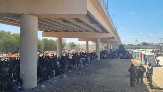 Thousands of migrants are camped out under the U.S. side of an international bridge that connects Mexico to Del Rio, Texas