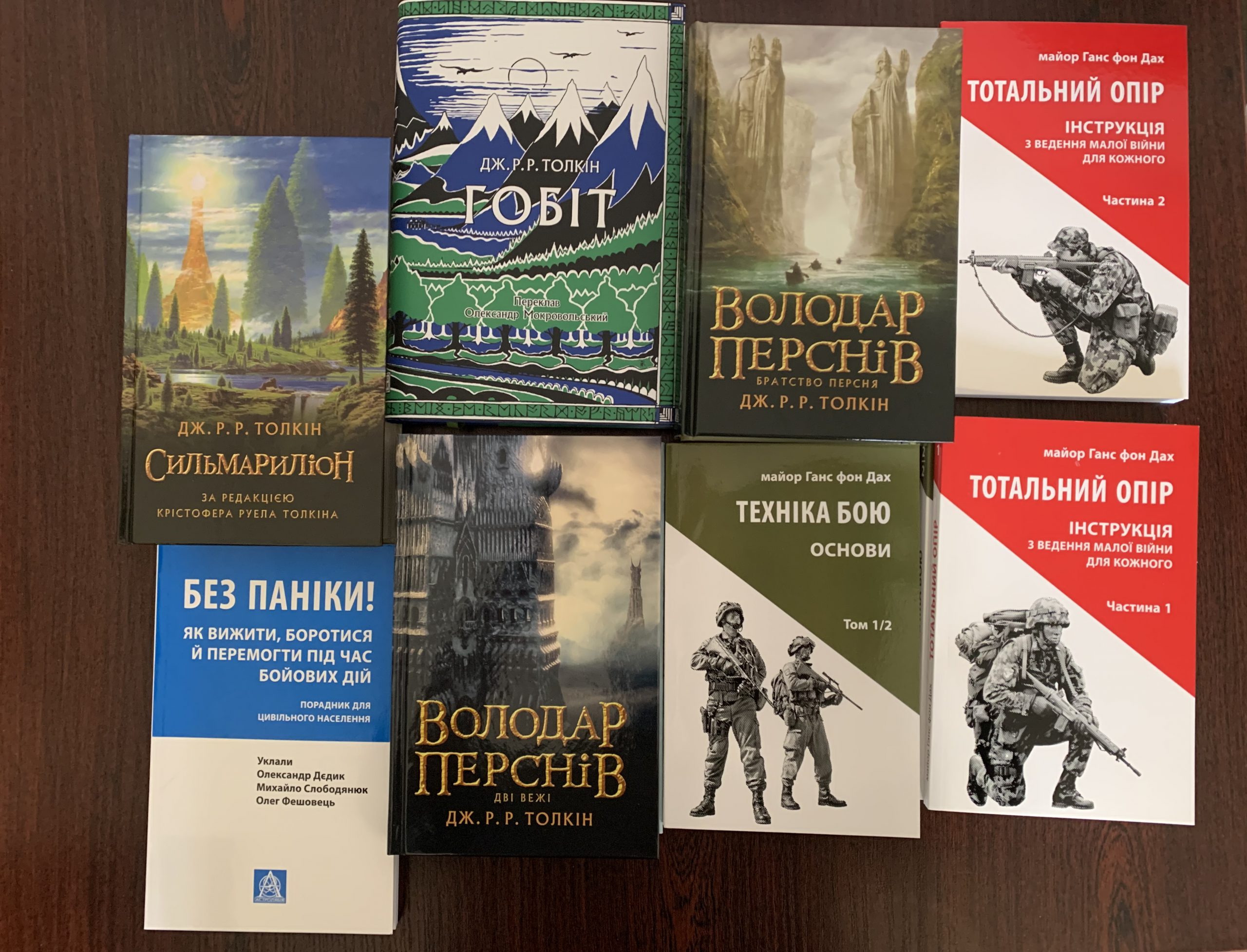 Ukrainian translations of J.R.R. Tolkien's "The Silmarillion," "The Hobbit," and "The Lord of the Rings" are seen alongside military-related books from Astrolabe Publishing.