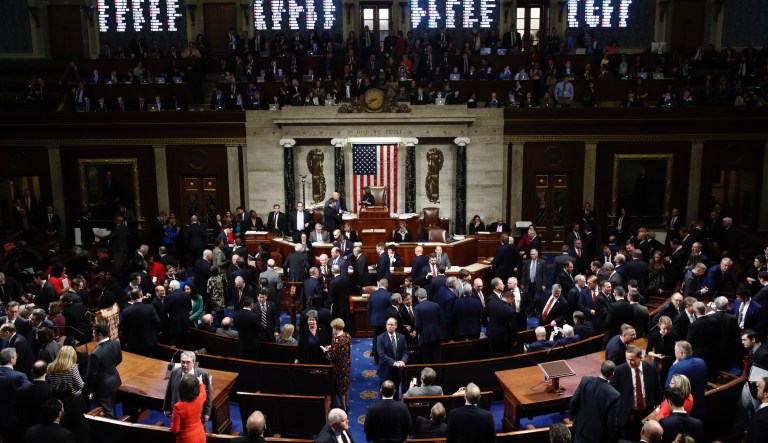 House members vote as House Speaker Nancy Pelosi of Calif., stands on the dais, during a vote on article II of impeachment against President Donald Trump, Wednesday, Dec. 18, 2019, on Capitol Hill in Washington.