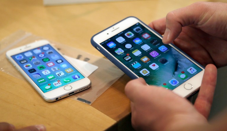 In this Friday, Sept. 16, 2016, file photo, a customer sets up his new iPhone 7 Plus, right, as he switches from the iPhone 6 at the Apple Store on Michigan Avenue during the release of the Apple iPhone 7 and the latest Apple Watches, in Chicago.