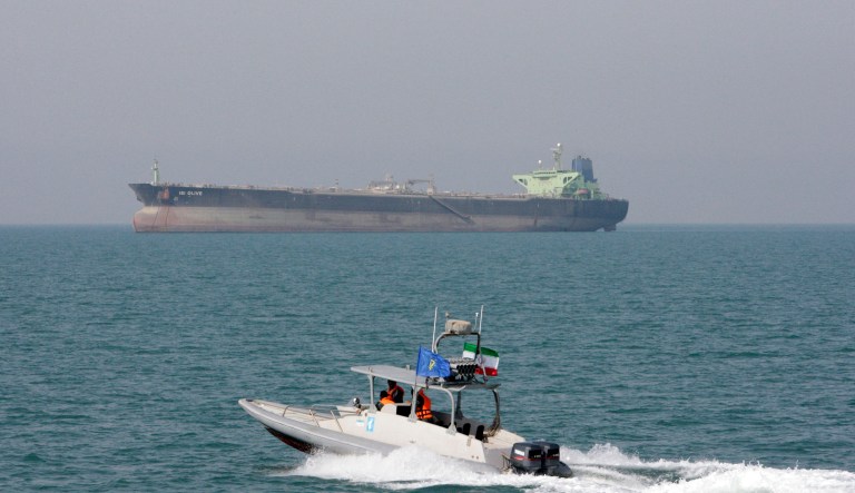 FILE-- In this July 2, 2012 file photo, an Iranian Revolutionary Guard speedboat moves in the Persian Gulf while an oil tanker is seen in background.