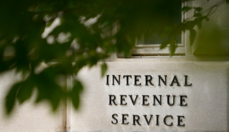 Signage is displayed outside the Internal Revenue Service (IRS) headquarters in Washington, D.C., U.S., on Friday, Oct. 20, 2017. President Donald Trump's top legislative priority took a major step forward as the Senate narrowly approved a budget vehicle for tax cuts -- but sharp divides over an array of non-binding amendments revealed the towering challenge he faces from here.